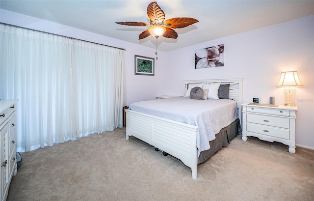 bedroom with ceiling fan and light colored carpet