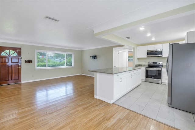 kitchen featuring white cabinets, stainless steel appliances, light hardwood / wood-style floors, and stone countertops