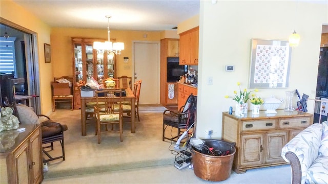 carpeted dining area featuring a healthy amount of sunlight and an inviting chandelier