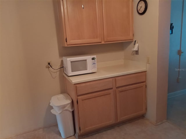 interior space featuring light tile patterned floors and light brown cabinets