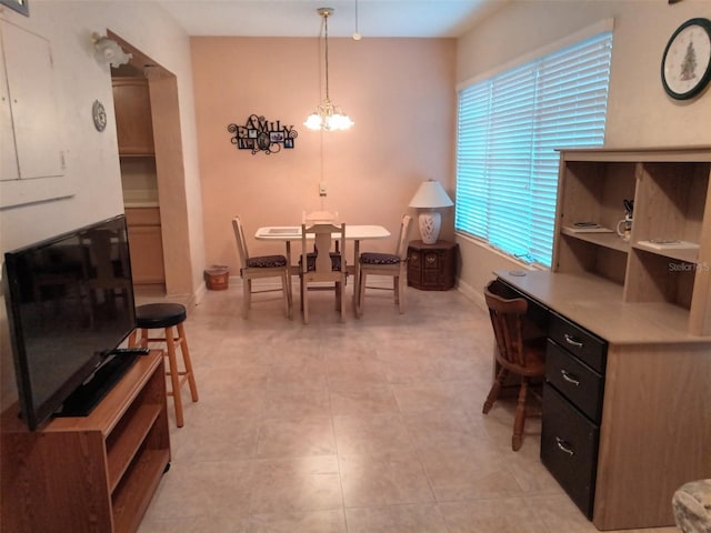 dining room with a notable chandelier and light tile patterned floors