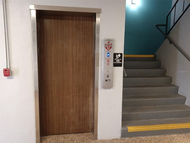 staircase featuring elevator