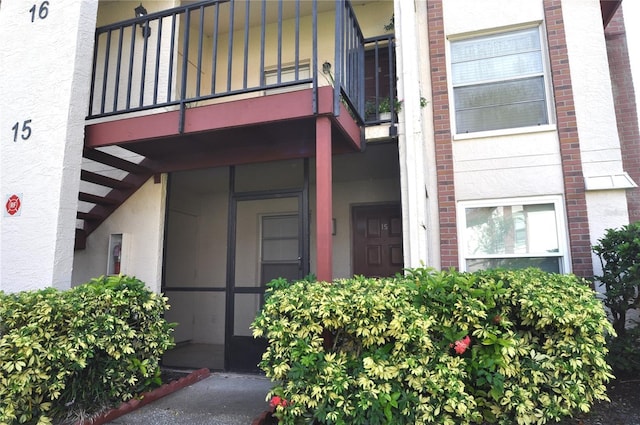 3455 Countryside Blvd Unit 15, Clearwater, FL 33761 - property entrance with a balcony and stucco siding