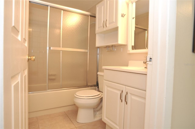 3455 Countryside Blvd Unit 15, Clearwater, FL 33761 - bathroom with vanity, toilet, tile patterned flooring, and combined bath / shower with glass door