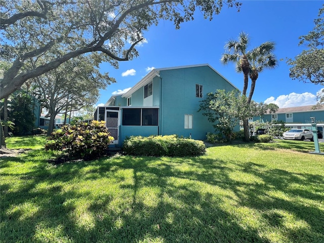 view of side of property featuring a lawn