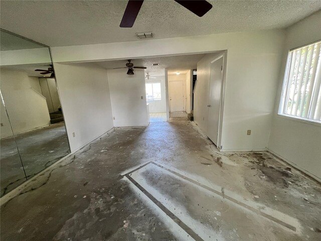 interior space with a healthy amount of sunlight, visible vents, and a textured ceiling