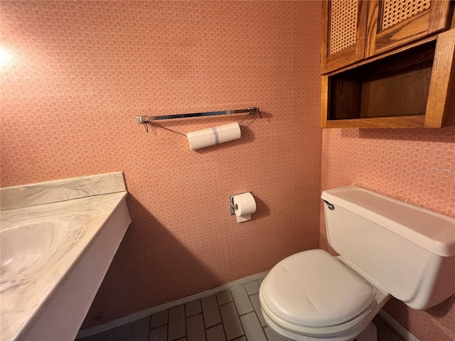 182 114th Ter NE Unit 182, Saint Petersburg, FL 33716 - half bathroom with baseboards, toilet, and wallpapered walls