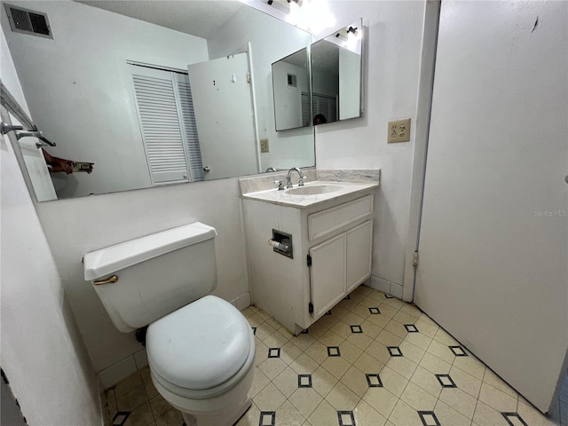 182 114th Ter NE Unit 182, Saint Petersburg, FL 33716 - bathroom with tile patterned floors, visible vents, toilet, and vanity