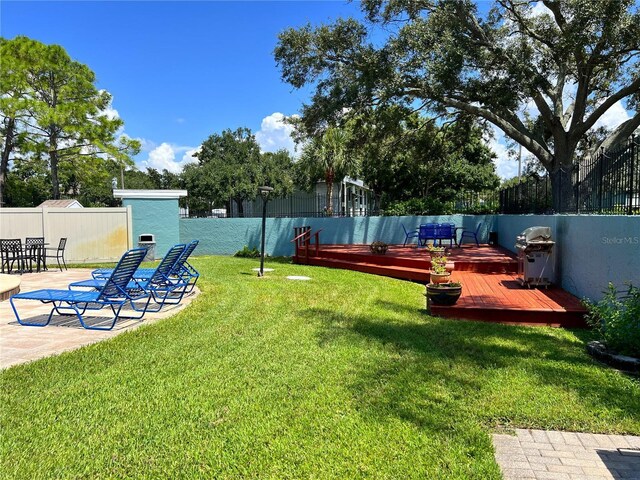 view of yard featuring a deck and fence