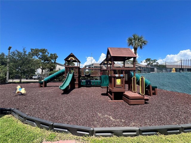 community jungle gym featuring fence