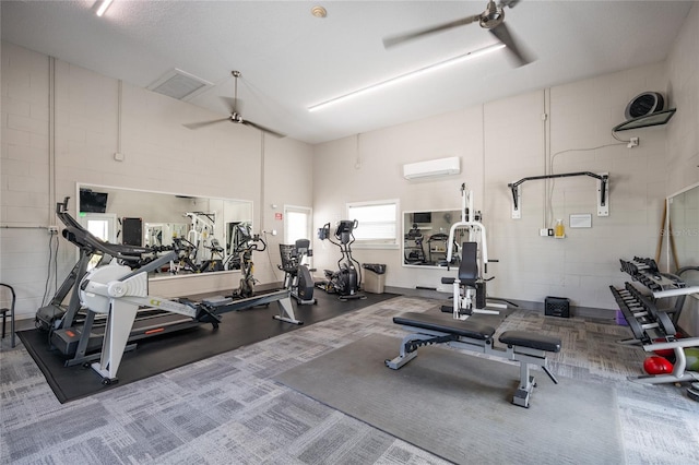 workout area featuring carpet floors, ceiling fan, a towering ceiling, and a wall unit AC