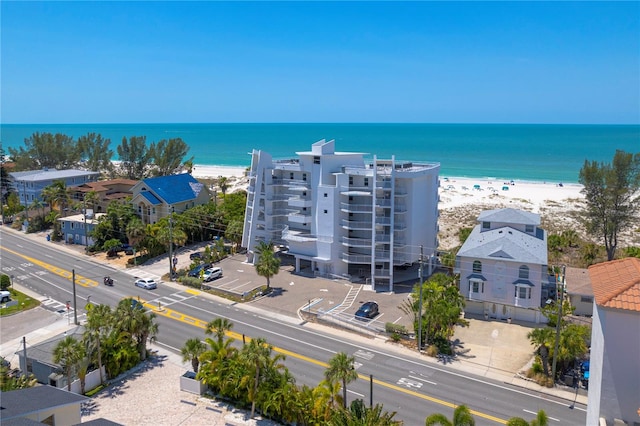 birds eye view of property with a water view and a beach view