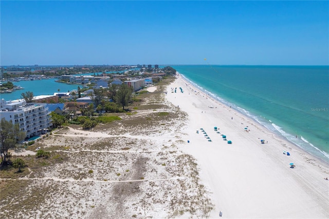 bird's eye view featuring a view of the beach and a water view