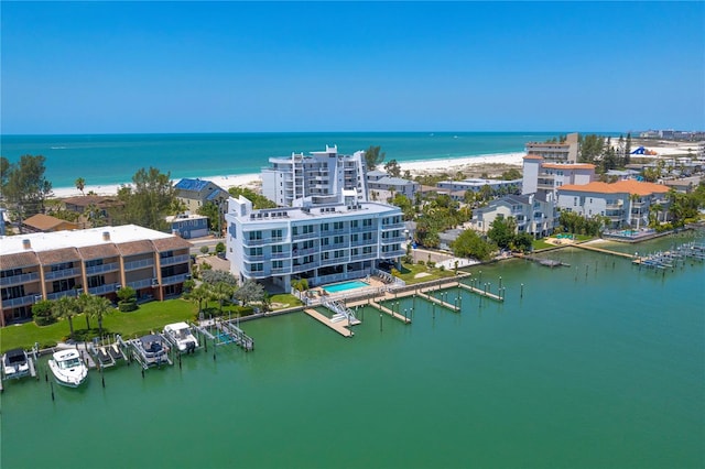 drone / aerial view with a beach view and a water view