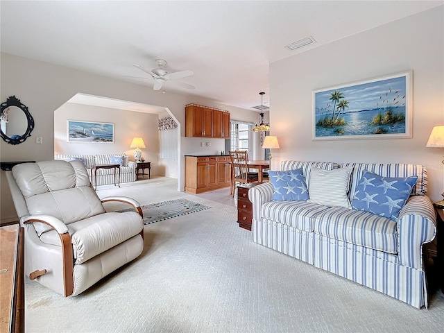 living room featuring light carpet, ceiling fan, and visible vents