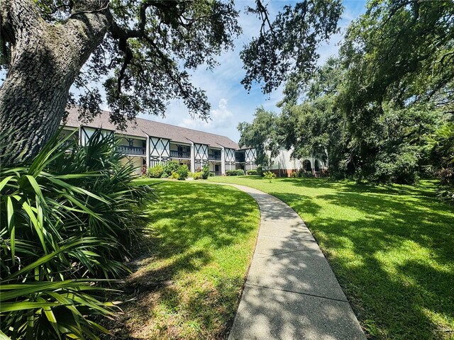 view of property's community featuring a yard