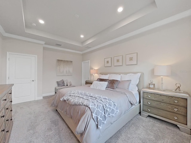 carpeted bedroom with a tray ceiling