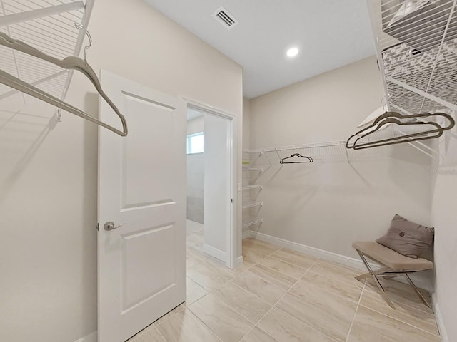 walk in closet featuring tile patterned flooring