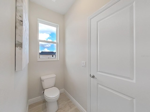 bathroom with toilet and tile patterned flooring