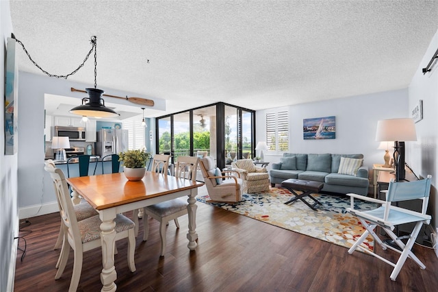 dining room featuring dark wood-type flooring and a textured ceiling