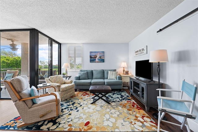 living room with a textured ceiling and hardwood / wood-style flooring