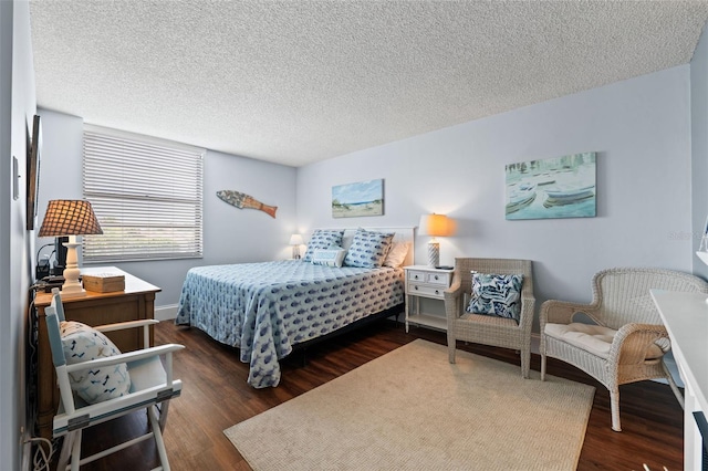 bedroom featuring a textured ceiling and dark hardwood / wood-style floors