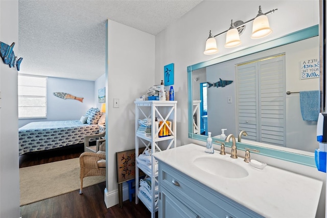 bathroom with vanity, a textured ceiling, and hardwood / wood-style floors