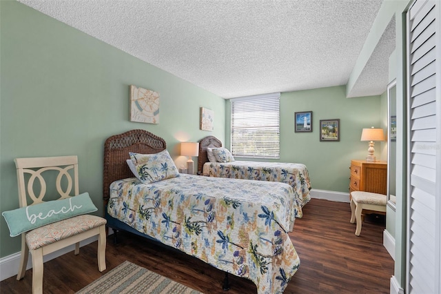 bedroom featuring a textured ceiling and dark hardwood / wood-style floors