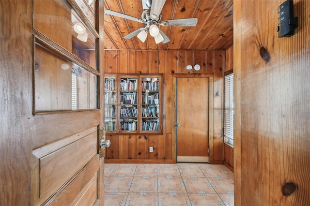 3108 58th St S, Gulfport, FL 33707 - doorway to outside featuring baseboards, wooden walls, light tile patterned flooring, ceiling fan, and wooden ceiling