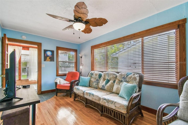 3108 58th St S, Gulfport, FL 33707 - living area with light wood-type flooring, baseboards, and ceiling fan