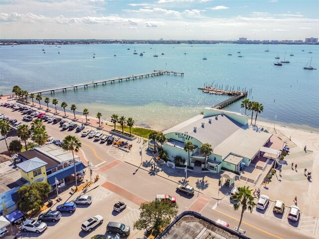 birds eye view of property with a water view and a beach view