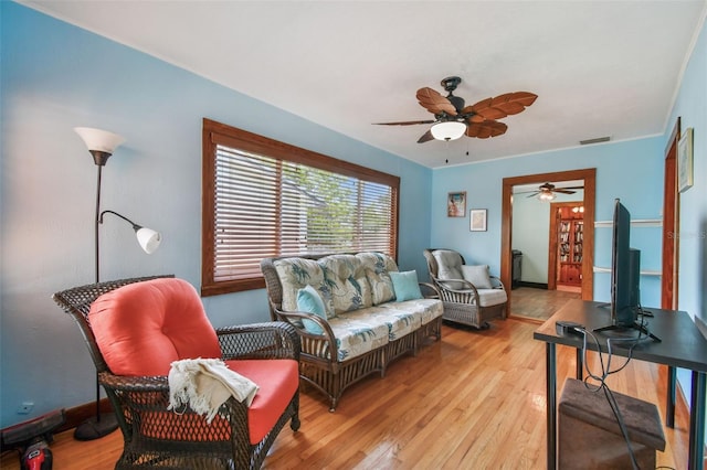 living room with ceiling fan and light wood-type flooring