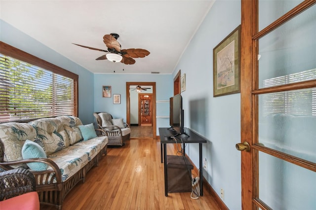 3108 58th St S, Gulfport, FL 33707 - living area with light wood-type flooring, ornamental molding, baseboards, and a ceiling fan