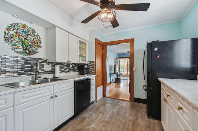 3108 58th St S, Gulfport, FL 33707 - kitchen featuring a sink, a ceiling fan, black appliances, wood finished floors, and decorative backsplash