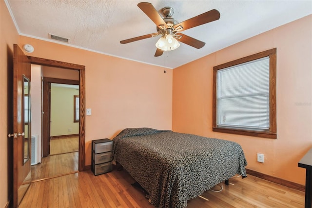 3108 58th St S, Gulfport, FL 33707 - bedroom featuring baseboards, a textured ceiling, wood-type flooring, and visible vents