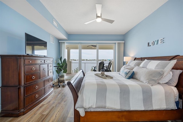 bedroom featuring light wood-type flooring, ceiling fan, and access to exterior