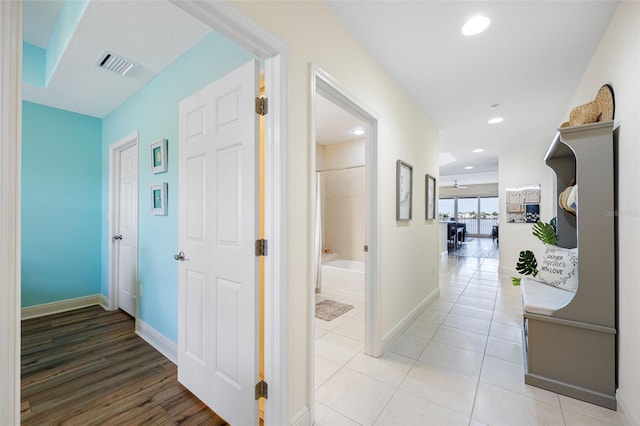 hall with tile patterned floors