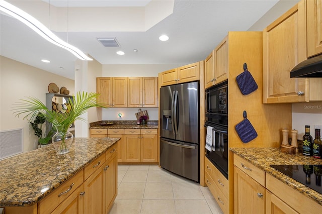 kitchen featuring black appliances, a kitchen island, light brown cabinetry, light tile patterned flooring, and dark stone countertops