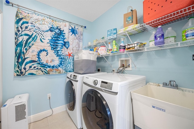 laundry room featuring light tile patterned flooring, sink, and independent washer and dryer