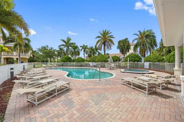 view of pool featuring a hot tub and a patio area