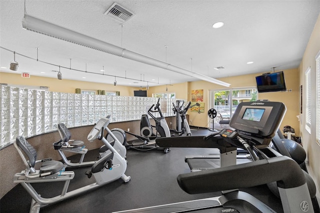 workout area featuring a textured ceiling