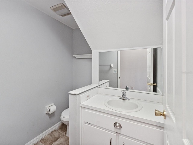 bathroom featuring toilet, vanity, and tile patterned floors