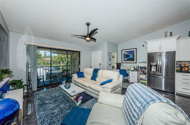 living room featuring ceiling fan, vaulted ceiling, a textured ceiling, and hardwood / wood-style flooring