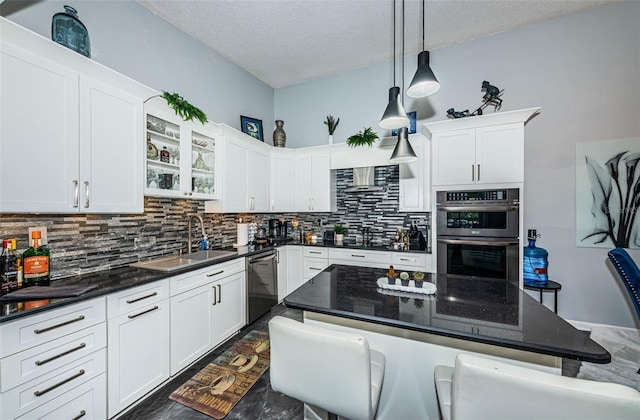 kitchen featuring a breakfast bar, dark stone countertops, decorative light fixtures, decorative backsplash, and stainless steel appliances