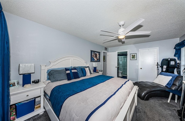 bedroom with a textured ceiling, carpet floors, ceiling fan, and connected bathroom