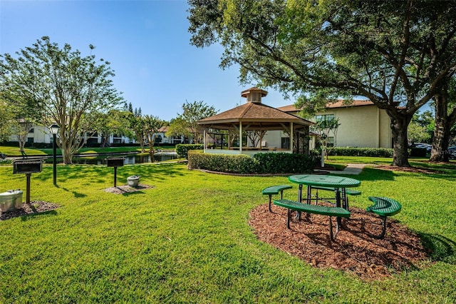 view of yard featuring a gazebo and a water view