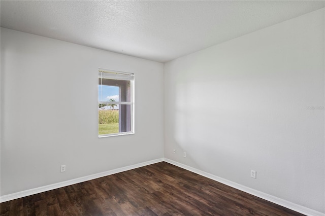 spare room featuring hardwood / wood-style floors and a textured ceiling