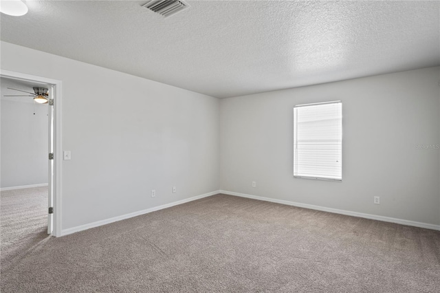 empty room with a textured ceiling, carpet, and ceiling fan