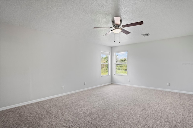 unfurnished room with ceiling fan, carpet, and a textured ceiling