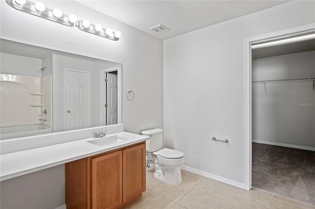 full bathroom with toilet, tile patterned floors, vanity, a textured ceiling, and washtub / shower combination